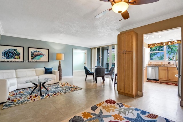 tiled living room featuring a textured ceiling, ceiling fan, and crown molding