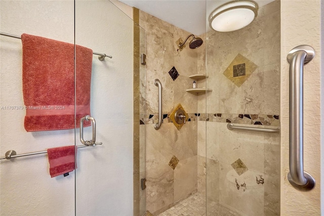 bathroom featuring a shower with door