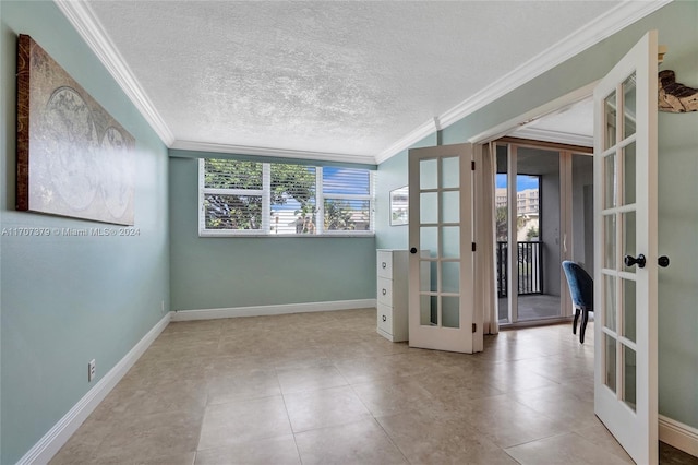 unfurnished room with plenty of natural light, a textured ceiling, and french doors