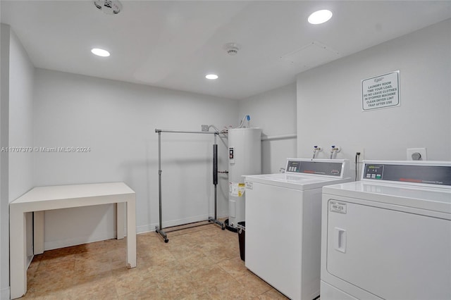 laundry room featuring washing machine and dryer and water heater