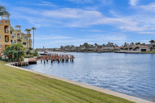 view of dock with a yard and a water view