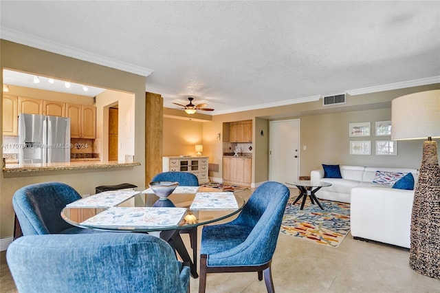 dining room with crown molding, ceiling fan, and a textured ceiling