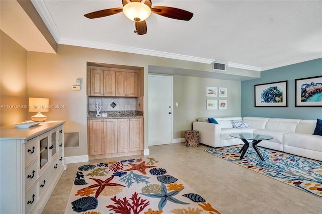 living room featuring light tile patterned floors, ceiling fan, and crown molding