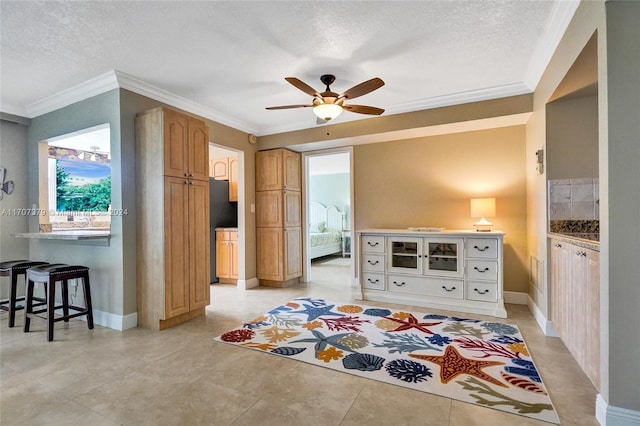 tiled bedroom with ceiling fan, ornamental molding, and a textured ceiling