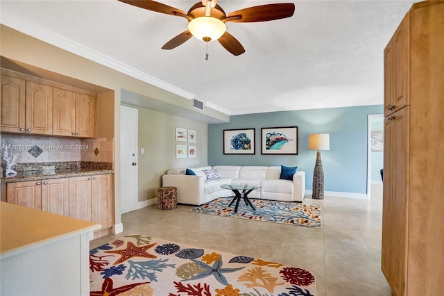 living room with ceiling fan, light tile patterned floors, and crown molding