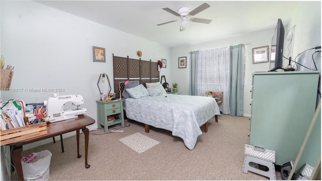 bedroom featuring light carpet and ceiling fan