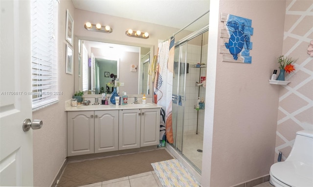 bathroom with tile patterned flooring, vanity, toilet, and a shower with door