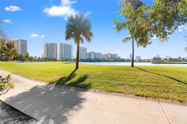 view of community with a yard and a water view