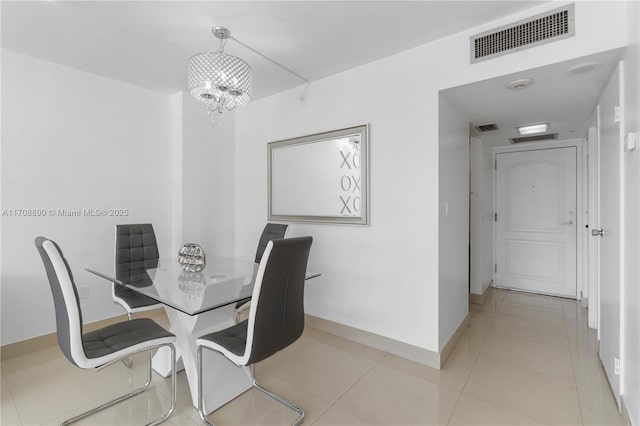 dining area featuring light tile patterned flooring and a chandelier