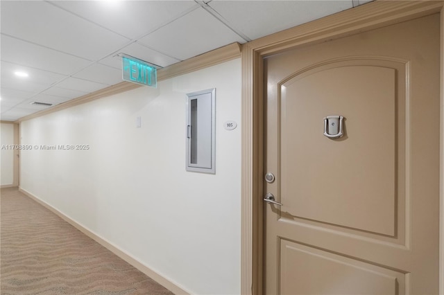 hallway featuring electric panel, crown molding, and carpet floors