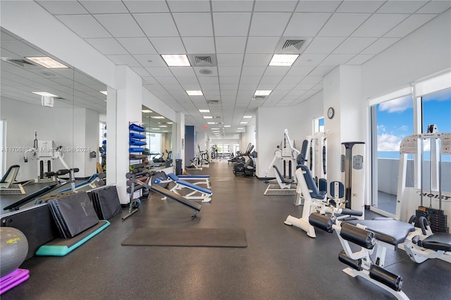 workout area featuring a paneled ceiling