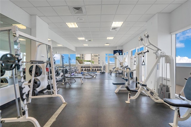 exercise room with a paneled ceiling