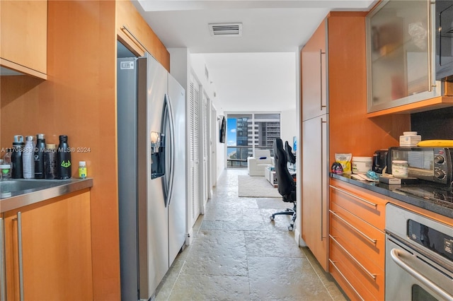 kitchen with expansive windows and stainless steel appliances