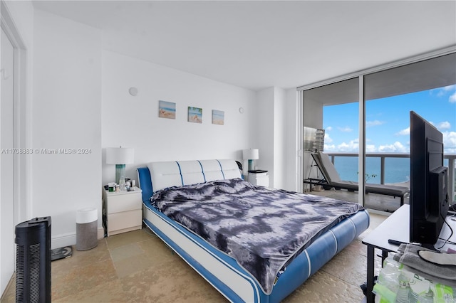 bedroom with expansive windows and access to outside