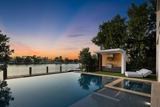 pool at dusk featuring a water view, a dock, and grilling area