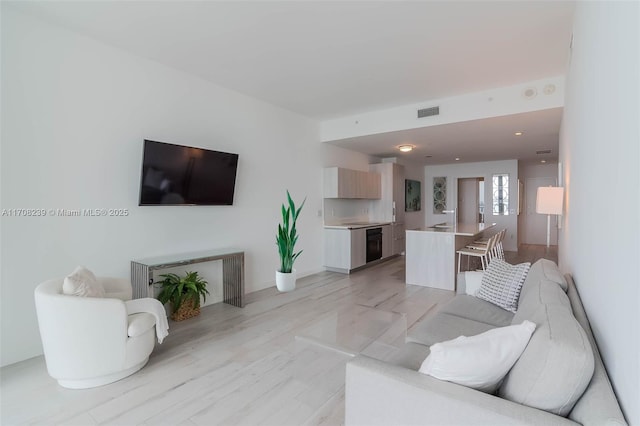 living room featuring visible vents and light wood-type flooring