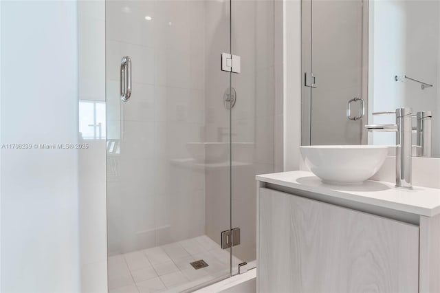 bathroom with vanity and a shower with shower door