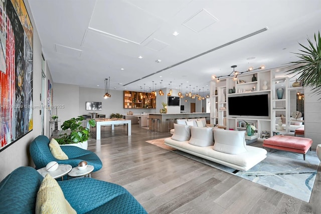 living room featuring recessed lighting, attic access, and wood finished floors