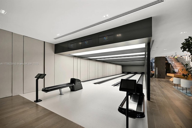 interior space with wood finished floors and bowling