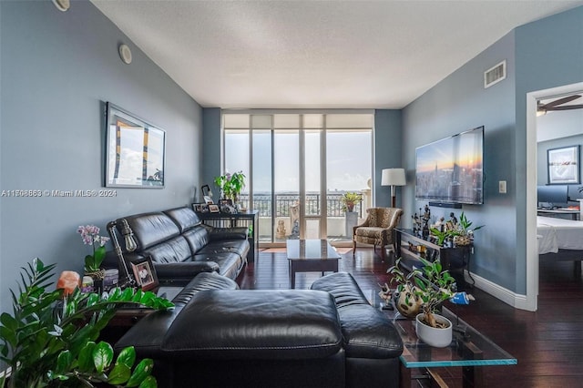 living room featuring wood-type flooring, a textured ceiling, floor to ceiling windows, and ceiling fan