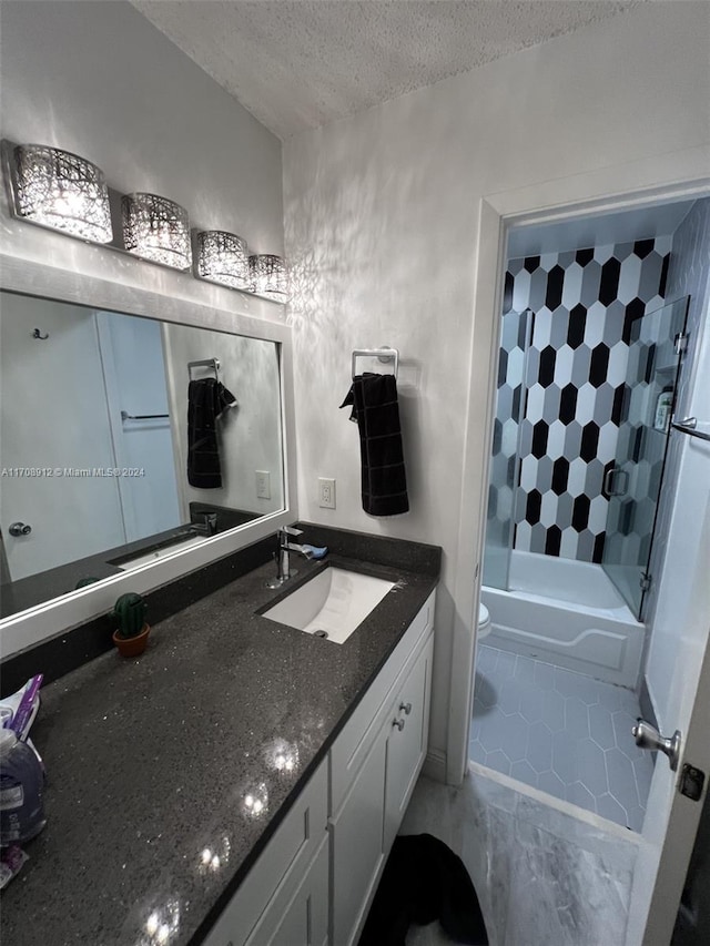 full bathroom featuring tiled shower / bath combo, toilet, a textured ceiling, and vanity