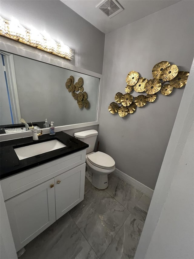 bathroom featuring vanity and toilet