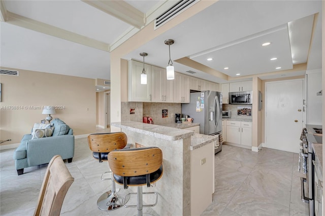 5055 Collins Ave Unit 14M, Miami Beach, FL 33140 - kitchen with appliances with stainless steel finishes, backsplash, a peninsula, open floor plan, and recessed lighting