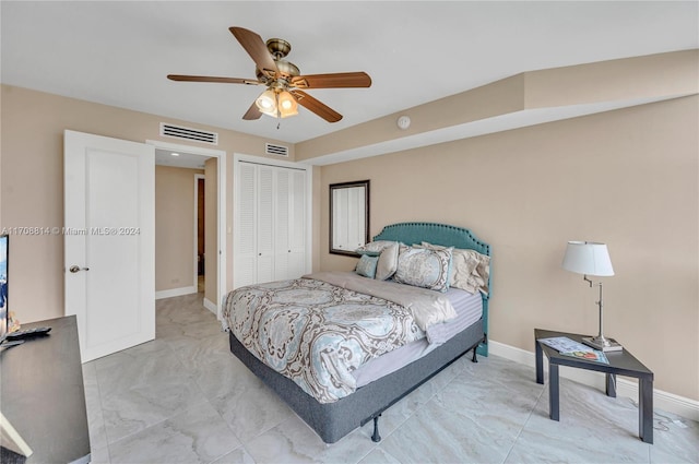 bedroom with ceiling fan and a closet