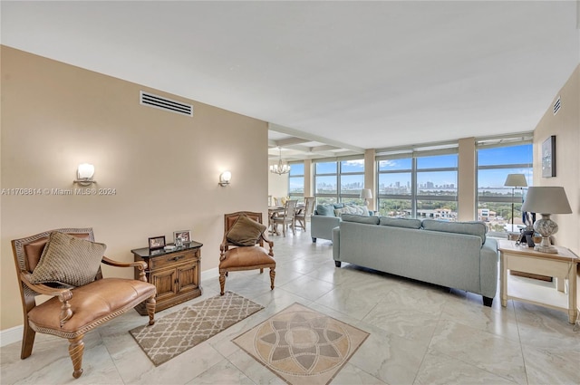 5055 Collins Ave Unit 14M, Miami Beach, FL 33140 - living area with plenty of natural light, floor to ceiling windows, a chandelier, and a view of city