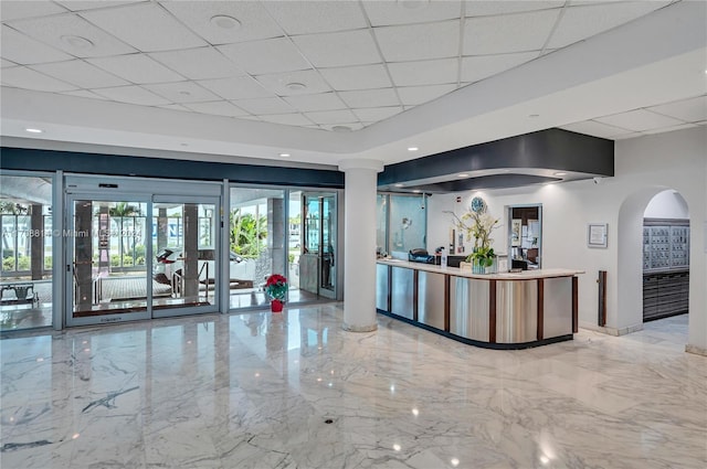 5055 Collins Ave Unit 14M, Miami Beach, FL 33140 - reception with a paneled ceiling, arched walkways, and decorative columns