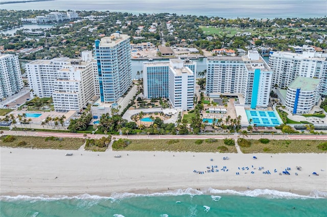 drone / aerial view featuring a water view and a beach view