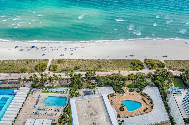 birds eye view of property with a view of the beach and a water view