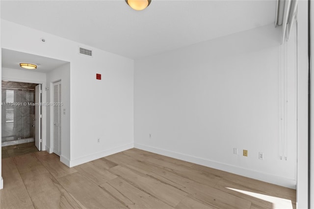 unfurnished room with light hardwood / wood-style floors