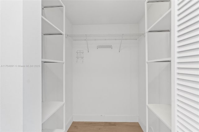 walk in closet featuring hardwood / wood-style floors