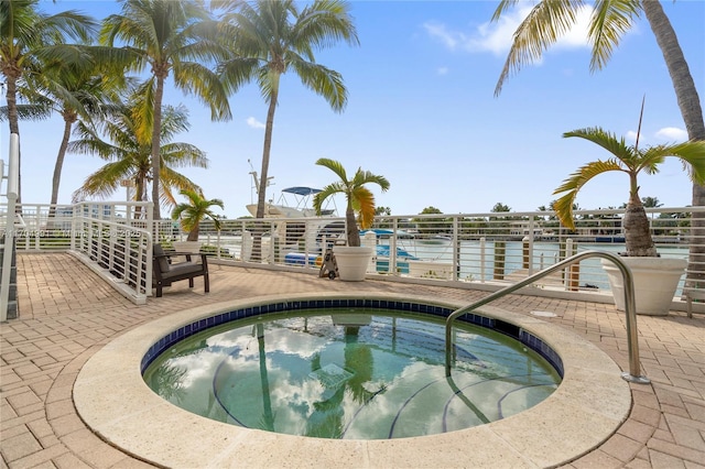 view of swimming pool with a patio area and a hot tub