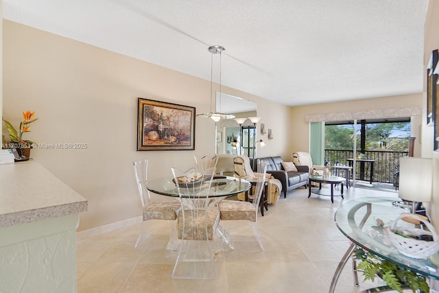 dining area featuring light tile patterned flooring and baseboards