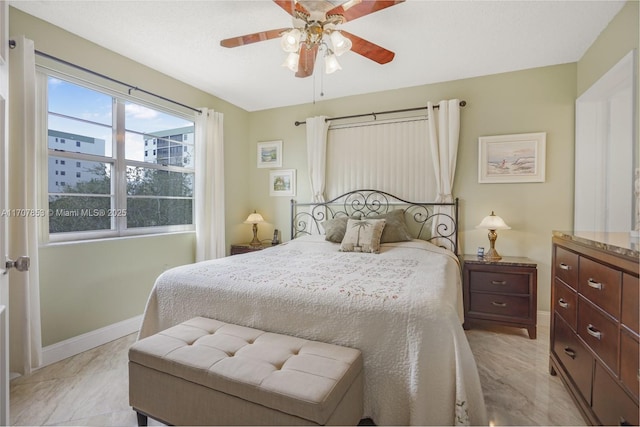 bedroom featuring a ceiling fan and baseboards