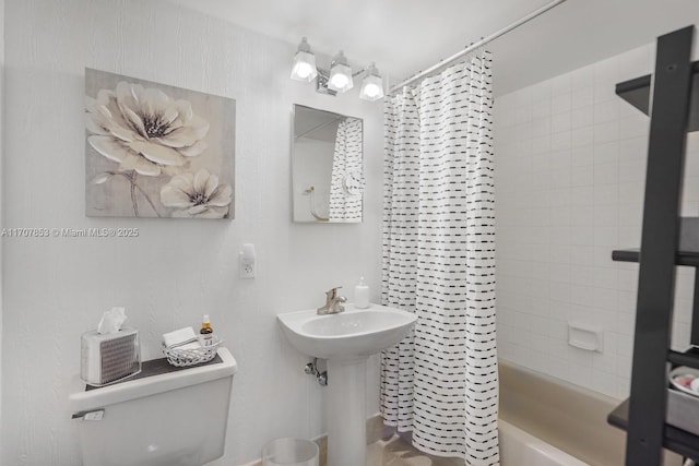 full bathroom featuring toilet and shower / bath combination with curtain