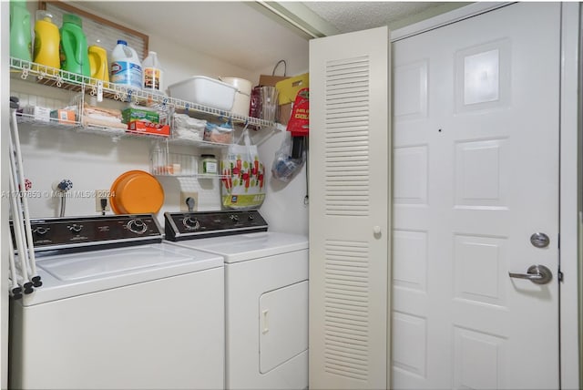 laundry area featuring washing machine and dryer and a textured ceiling