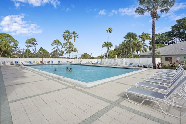 pool featuring a patio and fence