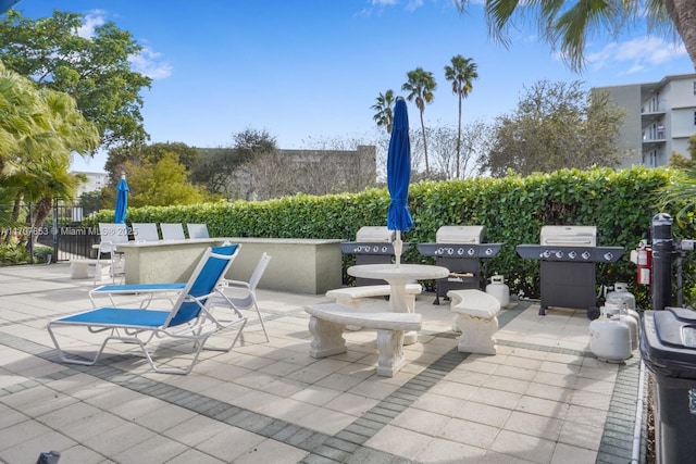 view of patio featuring grilling area and fence