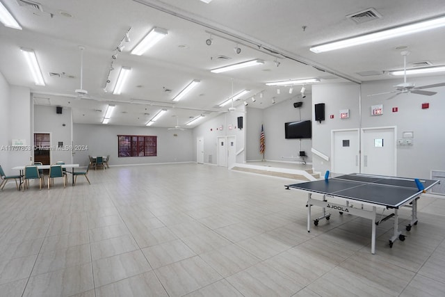 recreation room featuring high vaulted ceiling and ceiling fan