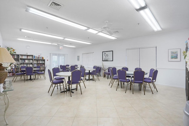 dining room with light tile patterned floors, a ceiling fan, and visible vents