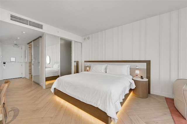 bedroom with light parquet floors