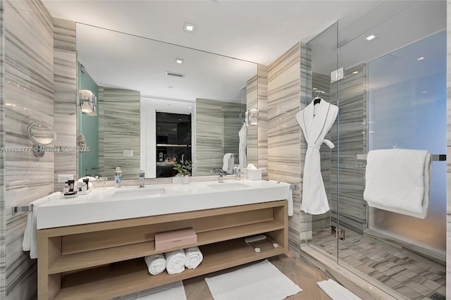 bathroom with tile walls, an enclosed shower, and vanity