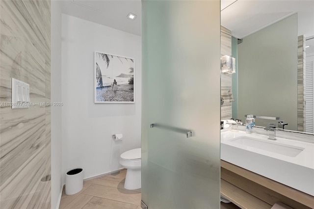 bathroom featuring toilet and vanity