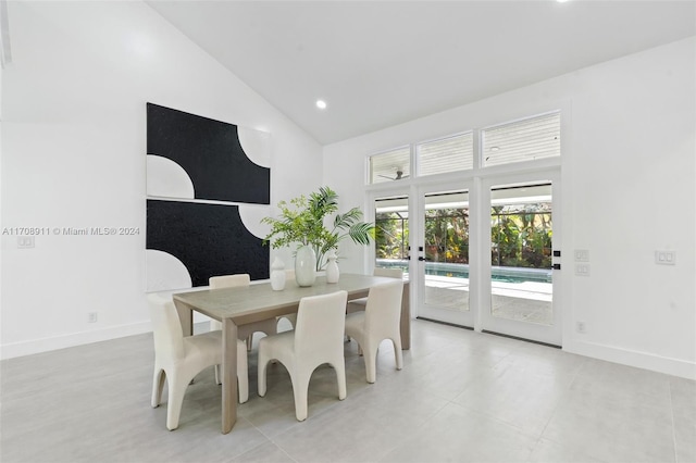 dining area with french doors and high vaulted ceiling