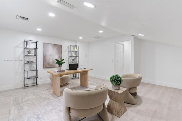 home office with light hardwood / wood-style floors