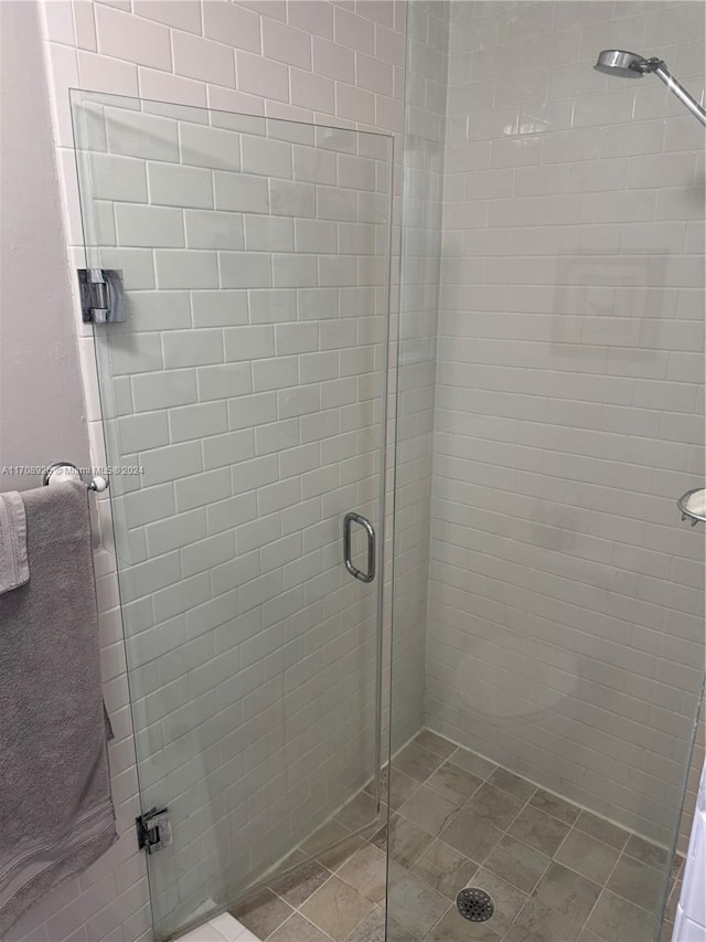 bathroom featuring a shower with door