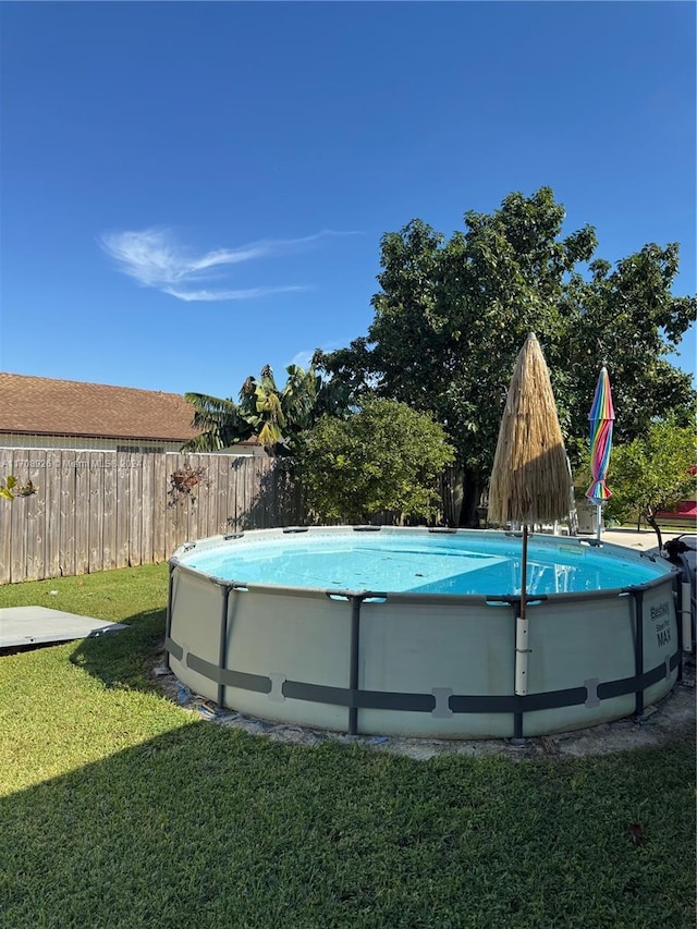 view of swimming pool featuring a lawn